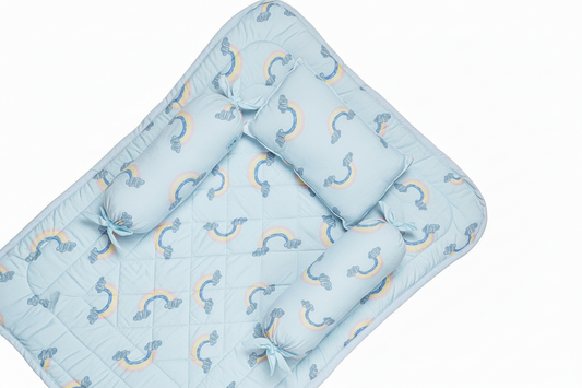 Blue bedding set with rainbow patterns and pillows on a white background