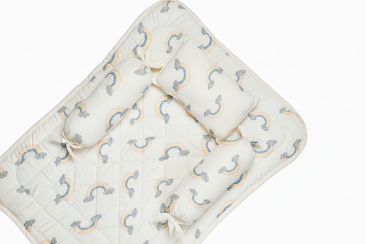 White bedding set with rainbow patterns and pillows on a white background